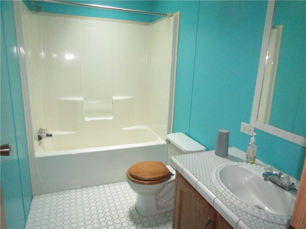 521 Williams Street Confluence, PA 15424 - Photo 9 of 38 a bathroom with a granite countertop sink toilet and shower