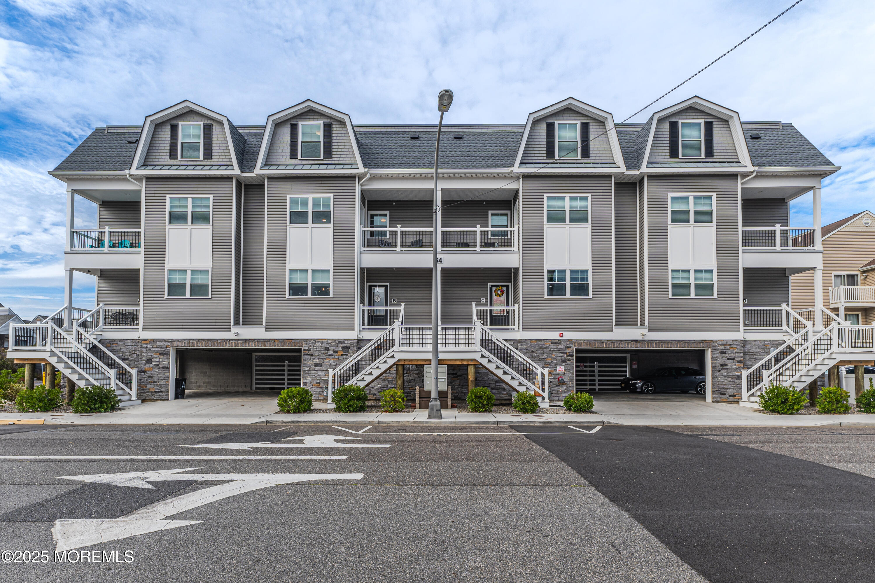 64 Sheridan Avenue, Unit B Seaside Heights, NJ 08751 - Photo 13 of 20 a front view of a house with a yard and a car parked