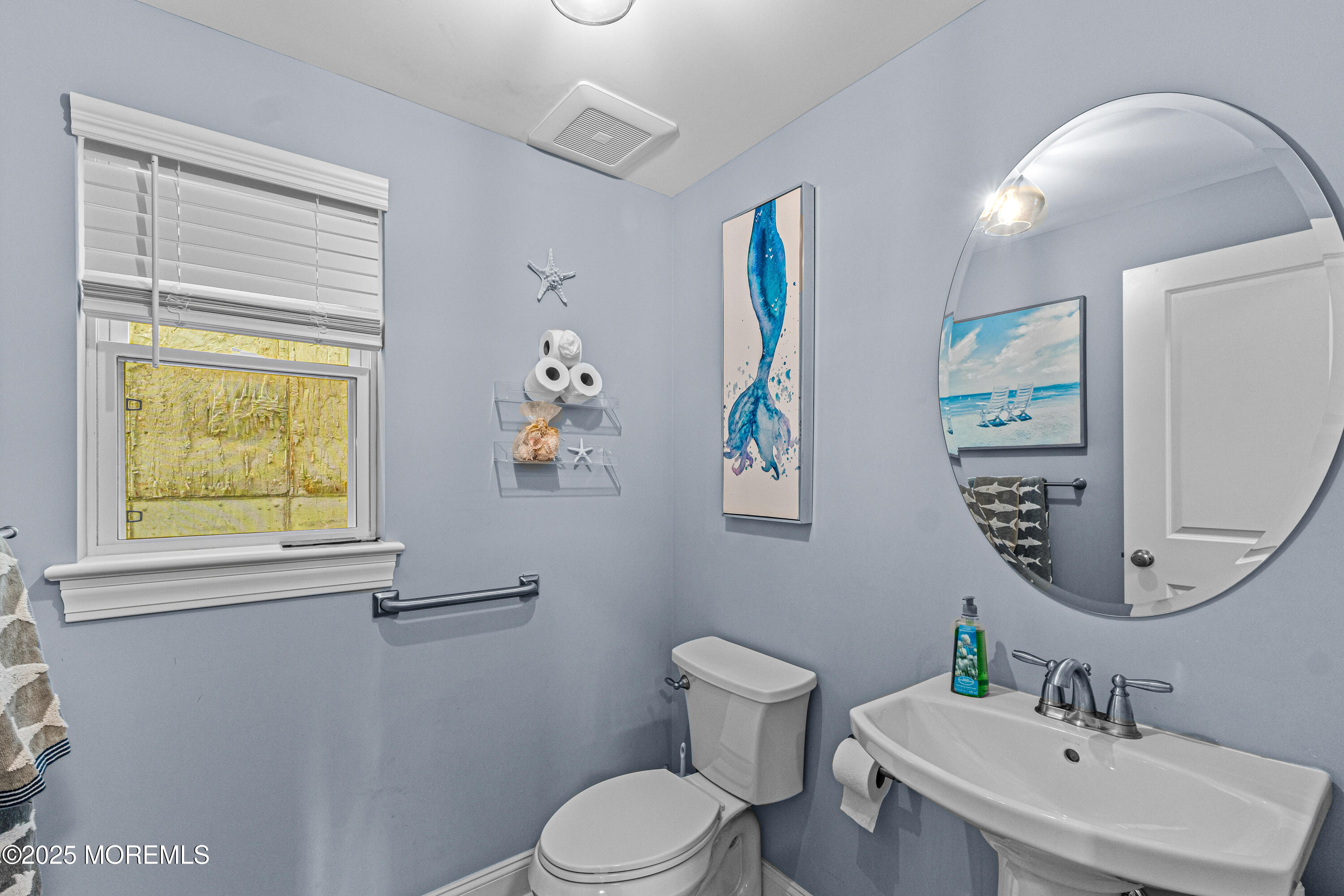 64 Sheridan Avenue, Unit B Seaside Heights, NJ 08751 - Photo 20 of 20 a bathroom with a toilet a sink a mirror a window and vanity