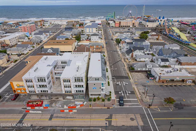 an aerial view of a building with streets and trees