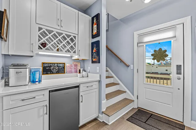 a kitchen with stainless steel appliances granite countertop a sink and a stove next to a window