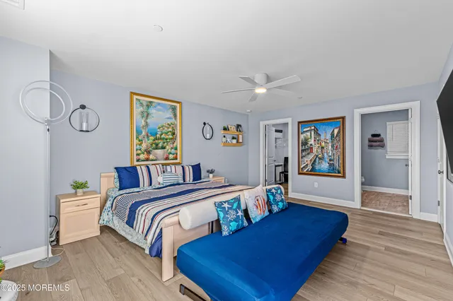 a bedroom with a bed and painting on the wall