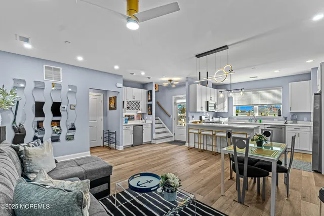 a living room with furniture and kitchen view