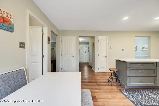 a view of a dining room with furniture and a chandelier