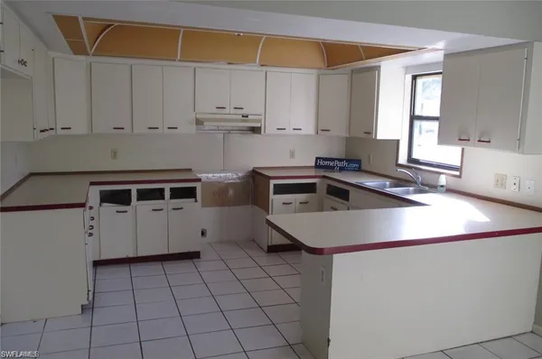a kitchen with a sink a stove and cabinets