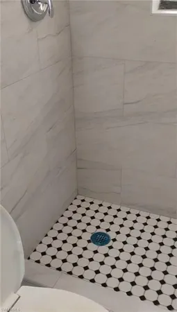 a bathroom with a black white checkered floor
