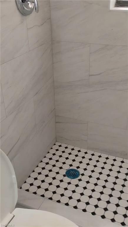5395 Carolina Avenue Naples, FL 34113 - Photo 3 of 11 a bathroom with a black white checkered floor