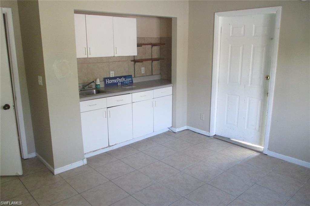 5395 Carolina Avenue Naples, FL 34113 - Photo 6 of 11 a room with a sink and cabinets