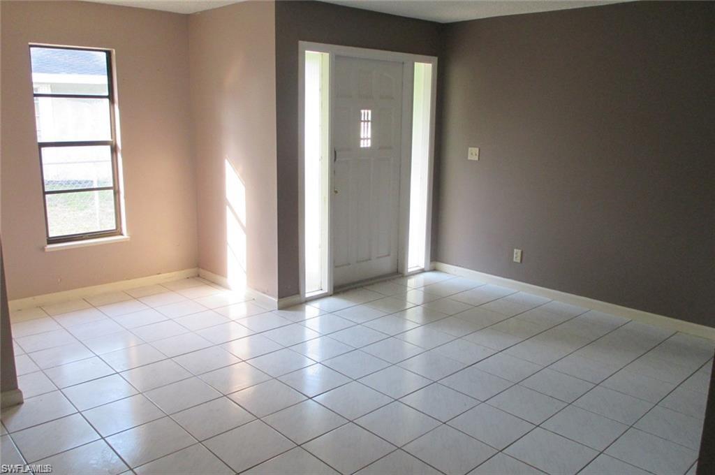 5395 Carolina Avenue Naples, FL 34113 - Photo 7 of 11 an empty room with windows