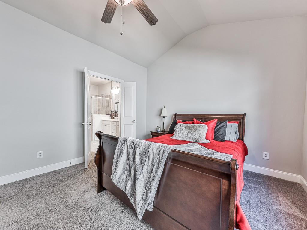 200 Lakeside Place Canton, GA 30114 - Photo 15 of 38 a bedroom with a bed and a chandelier