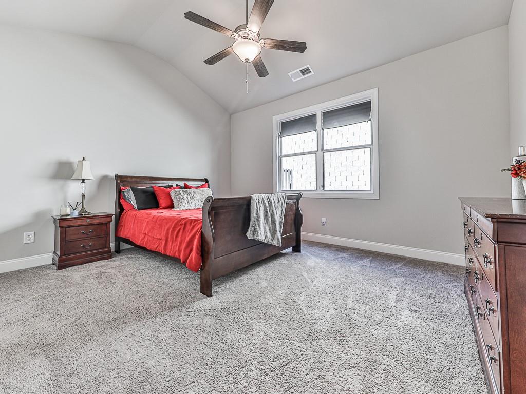 200 Lakeside Place Canton, GA 30114 - Photo 16 of 38 a spacious bedroom with a bed and a chandelier
