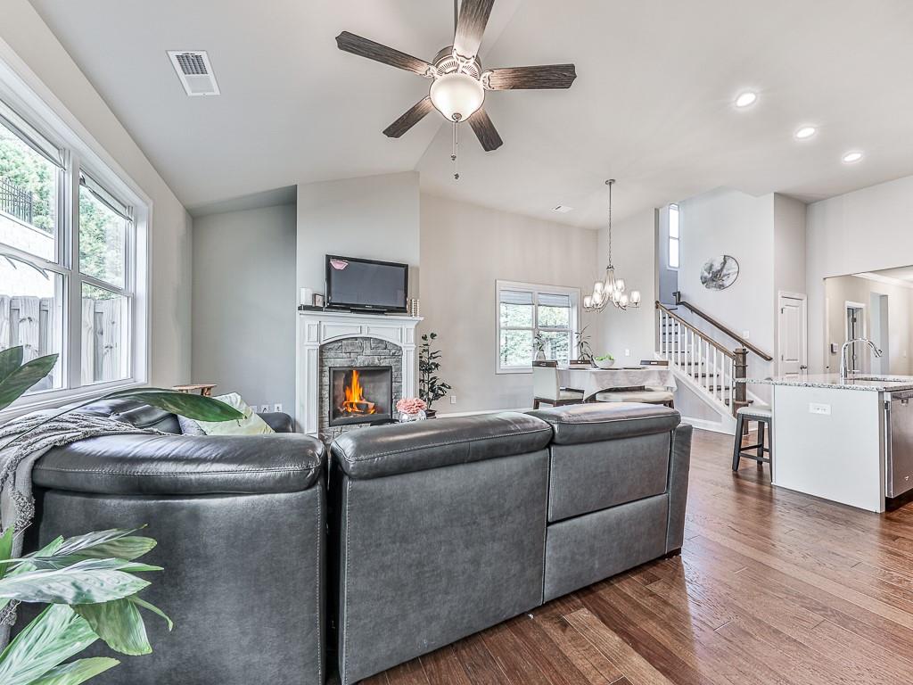 200 Lakeside Place Canton, GA 30114 - Photo 18 of 38 a living room with furniture a fireplace and a large window