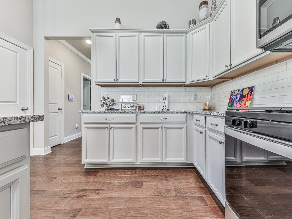 200 Lakeside Place Canton, GA 30114 - Photo 24 of 38 a kitchen with stainless steel appliances a sink stove and cabinets