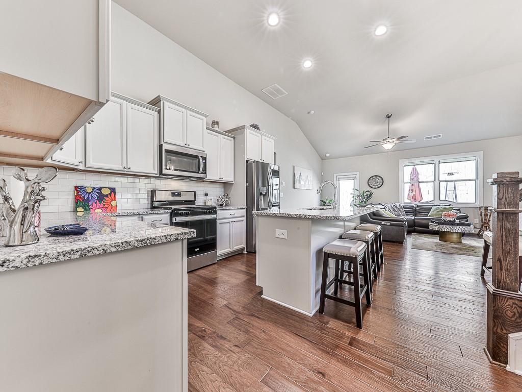 200 Lakeside Place Canton, GA 30114 - Photo 27 of 38 a kitchen with granite countertop lots of counter top space and furniture