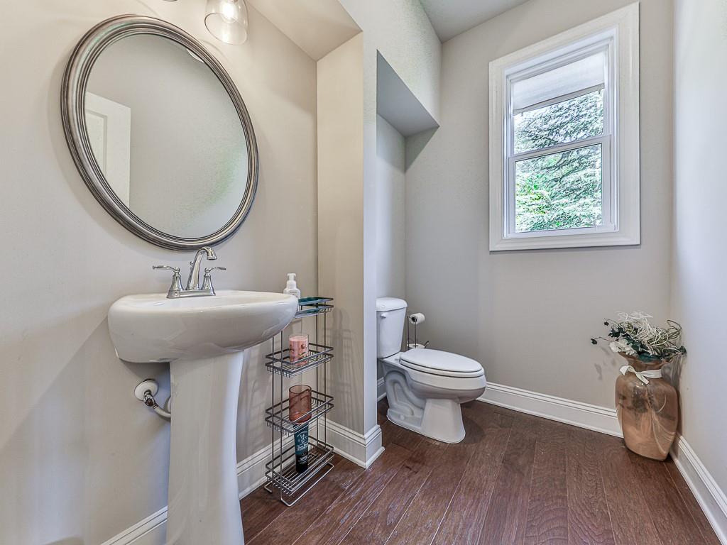 200 Lakeside Place Canton, GA 30114 - Photo 4 of 38 a bathroom with a toilet a sink and a mirror