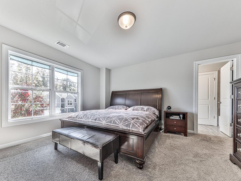 200 Lakeside Place Canton, GA 30114 - Photo 7 of 38 a bedroom with a bed and a large window