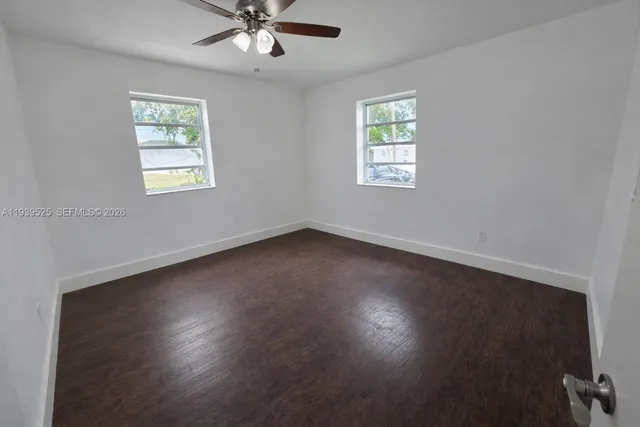 a view of room with window and hardwood floor