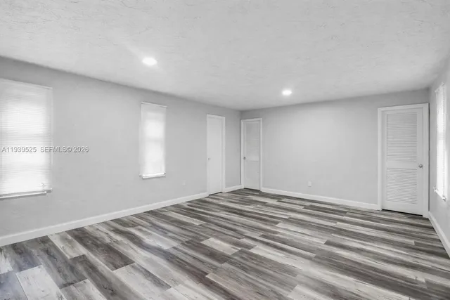 a view of a room with wooden floor and window
