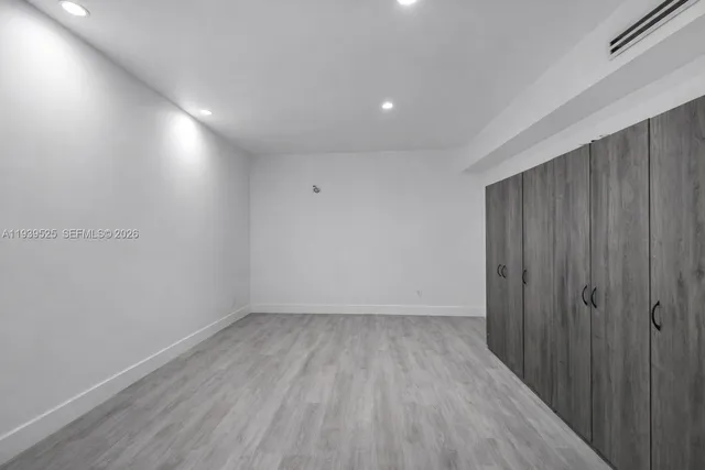 a view of room with wooden floor