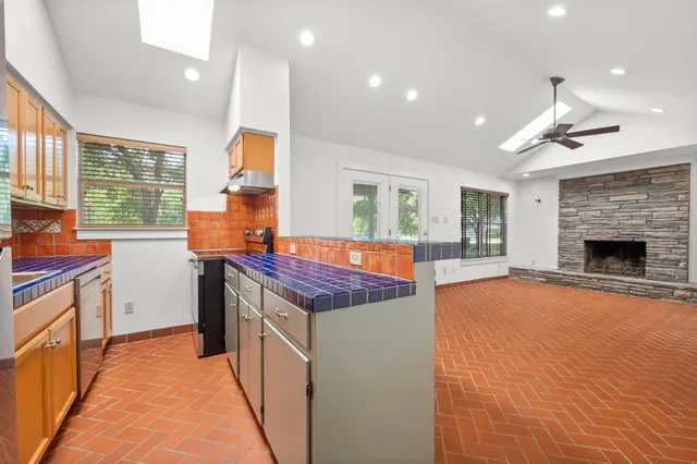 a kitchen with stainless steel appliances granite countertop a stove and a kitchen island