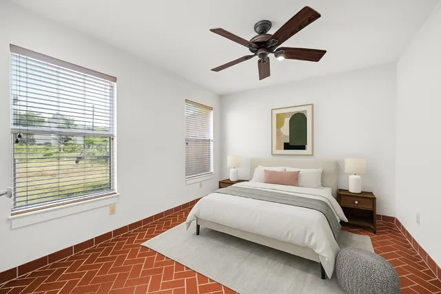 a bedroom with a bed and window