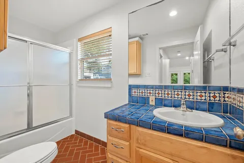 a bathroom with a sink a mirror and a toilet