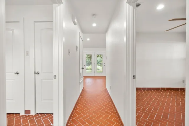 a view of a hallway with wooden floor and entryway