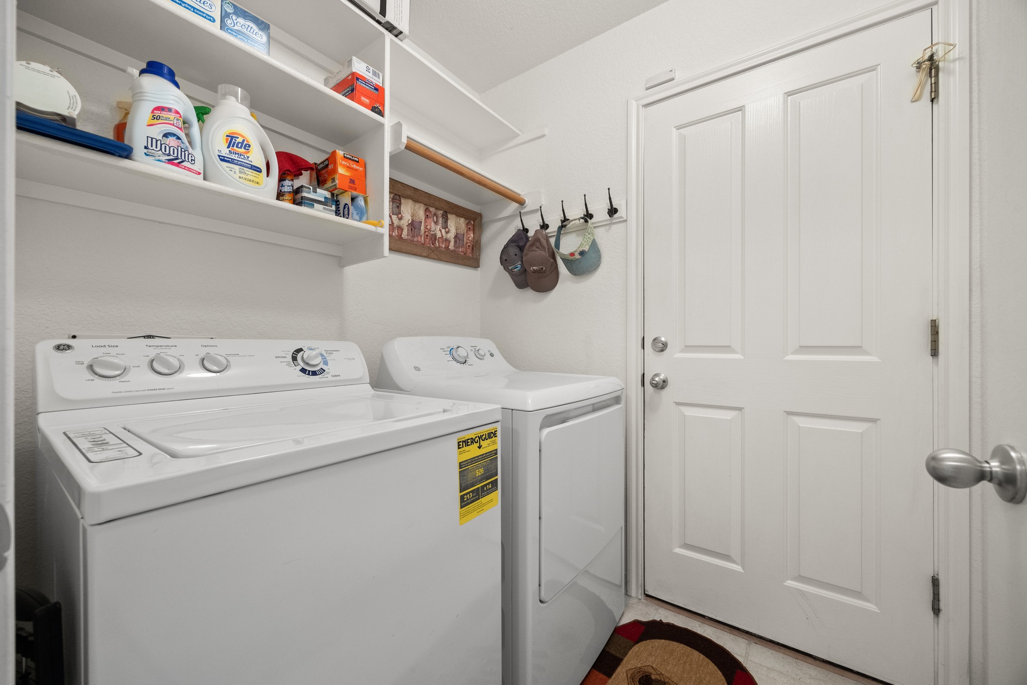 1108 Springbrook Road Pflugerville, TX 78660 - Photo 26 of 37 Functional laundry space featuring a washer, dryer, and convenient shelving.