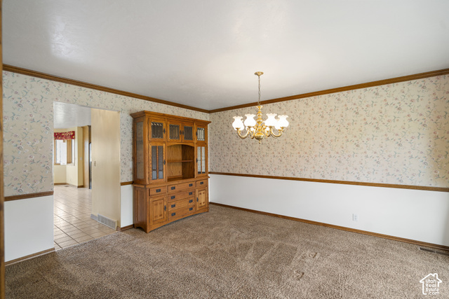 1373 Pheasant Ridge Circle Bountiful, UT 84010 - Photo 17 of 50 Carpeted room featuring a gold-toned chandelier, patterned wallpaper with chair rail, and an archway opening