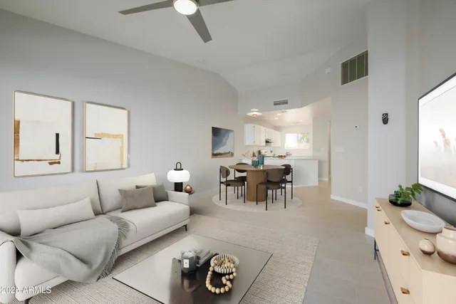 a living room with furniture and a dining table