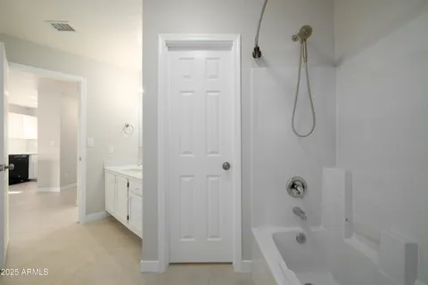 a bathroom with a tub a sink and shower