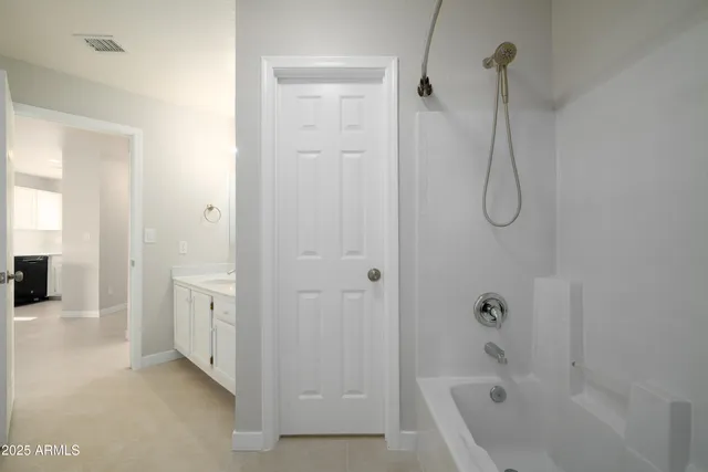 a bathroom with a tub a sink and shower