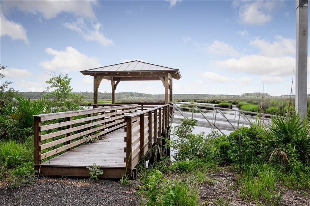 0 Iron Safe Road Brunswick, GA 31523 - Photo 3 of 26 a view of a bench in a backyard