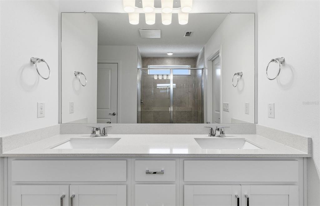 36877 Rio Grande Drive Zephyrhills, FL 33540 - Photo 11 of 26 a bathroom with a sink double vanity and a mirror