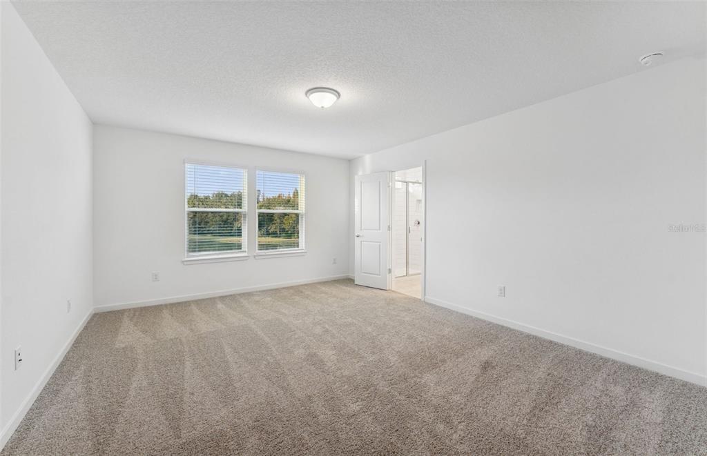 36877 Rio Grande Drive Zephyrhills, FL 33540 - Photo 12 of 26 an empty room with windows