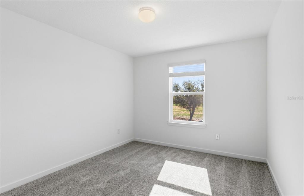 36877 Rio Grande Drive Zephyrhills, FL 33540 - Photo 13 of 26 an empty room with a window