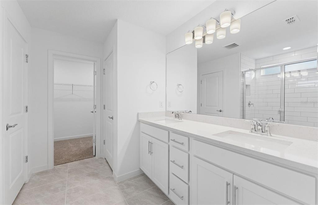 36877 Rio Grande Drive Zephyrhills, FL 33540 - Photo 13 of 26 a bathroom with a double vanity sink and a mirror