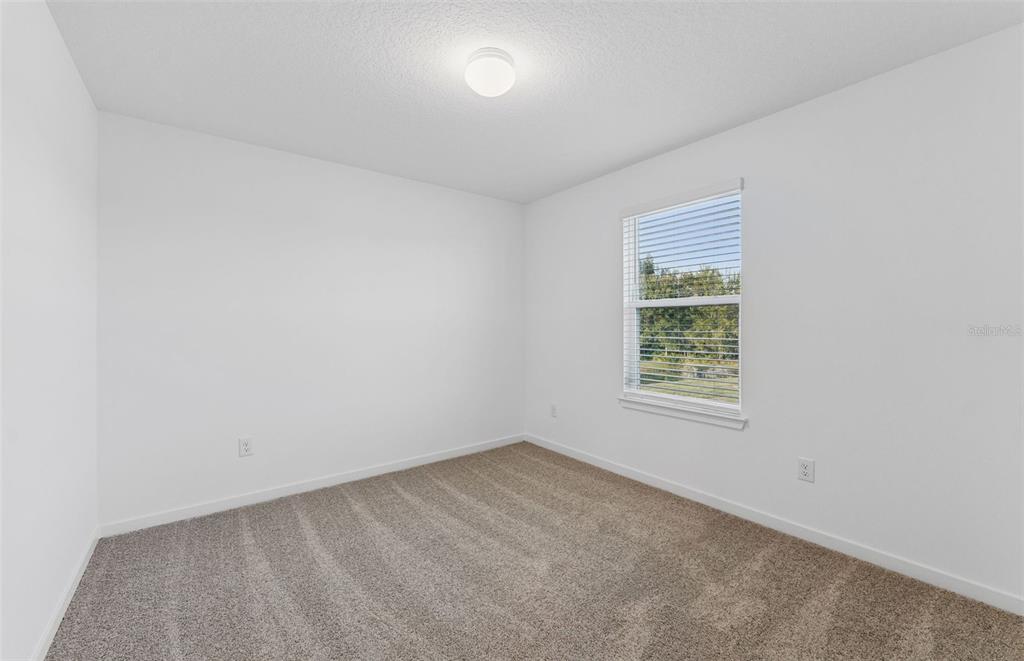 36877 Rio Grande Drive Zephyrhills, FL 33540 - Photo 17 of 26 an empty room with a window