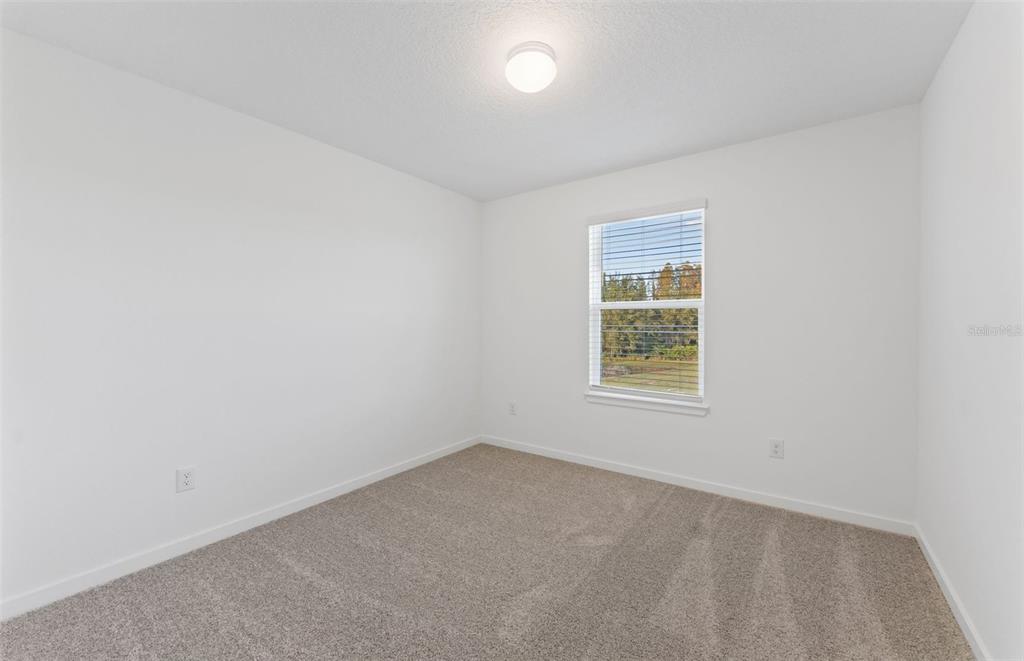 36877 Rio Grande Drive Zephyrhills, FL 33540 - Photo 18 of 26 an empty room with a window