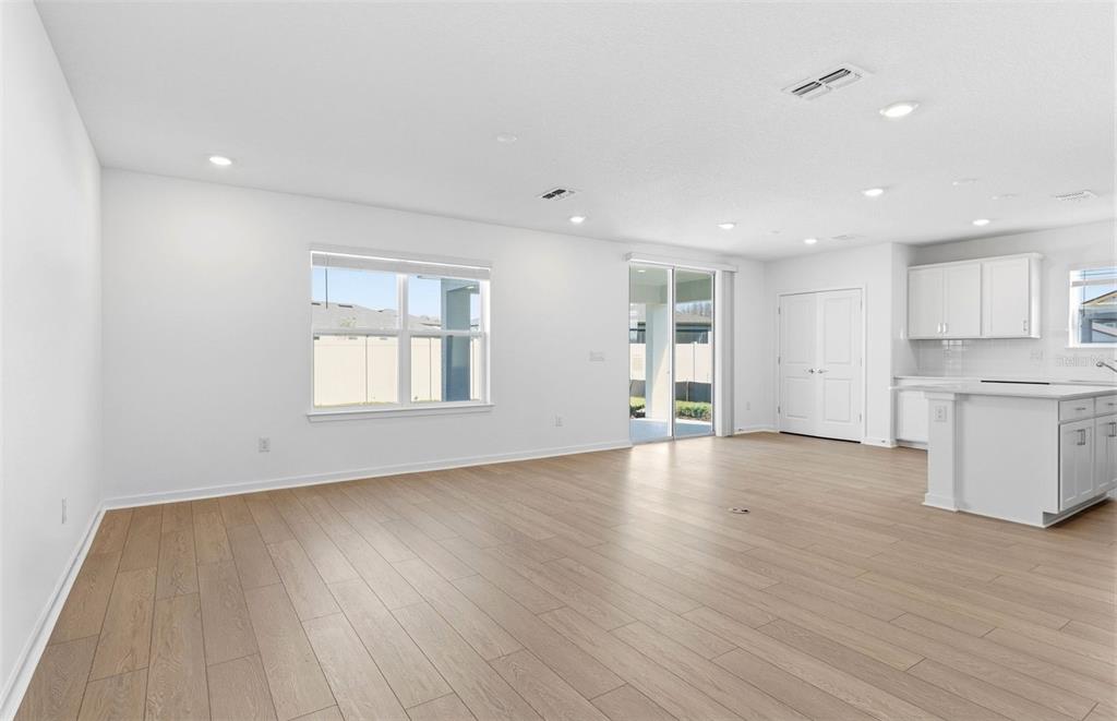 36877 Rio Grande Drive Zephyrhills, FL 33540 - Photo 6 of 26 a view of empty room with wooden floor and window