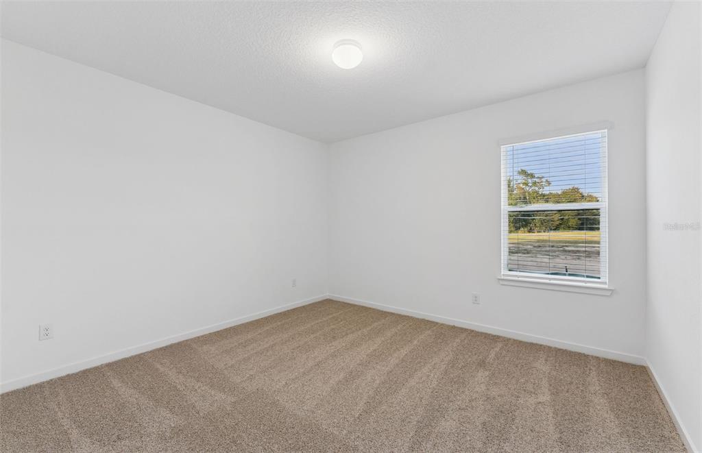36877 Rio Grande Drive Zephyrhills, FL 33540 - Photo 8 of 26 an empty room with a window