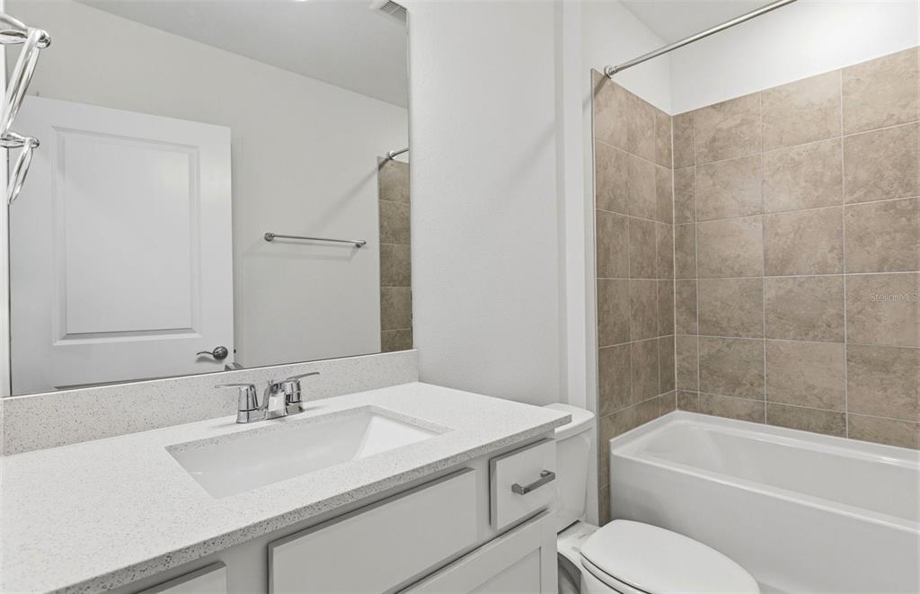 36877 Rio Grande Drive Zephyrhills, FL 33540 - Photo 8 of 26 a bathroom with a sink toilet tub and shower