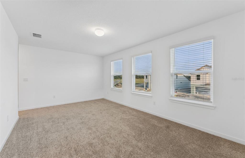 36877 Rio Grande Drive Zephyrhills, FL 33540 - Photo 10 of 26 an empty room with windows