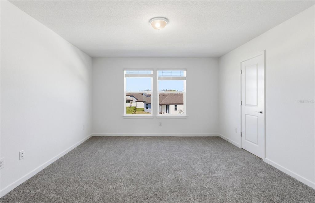 36877 Rio Grande Drive Zephyrhills, FL 33540 - Photo 10 of 26 an empty room with windows