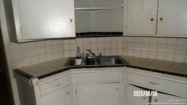 a kitchen with a sink and cabinets