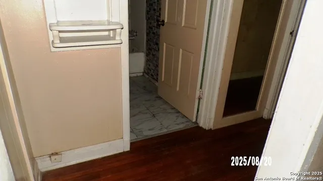 a view of a hallway with wooden floor