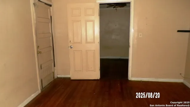 an empty room with wooden floor