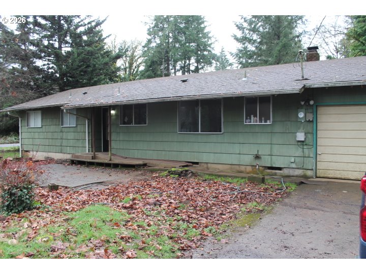 a view of a house with a backyard and trees