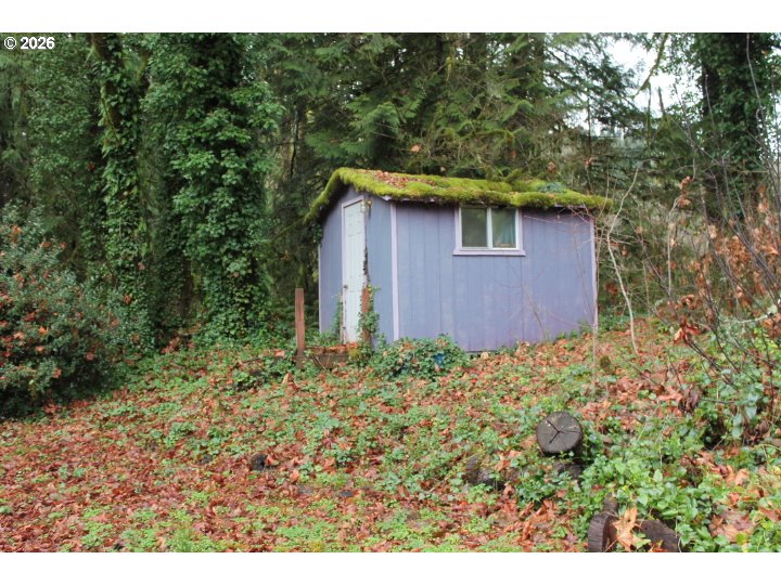 21620 Glaze Road Veneta, OR 97487 - Photo 17 of 36 a view of a wooden house with a yard