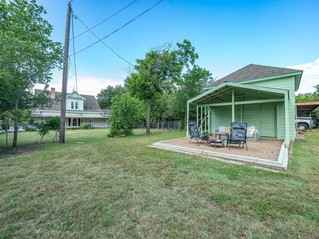 907 4th Street Graham, TX 76450 - Photo 27 of 34 a view of a house with backyard porch and sitting area